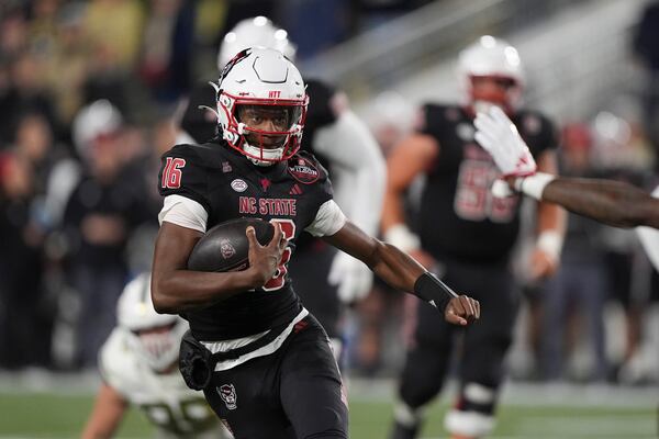 North Carolina State quarterback CJ Bailey (16) runs the ball during the first half of an NCAA college football game against Georgia Tech, Thursday, Nov. 21, 2024, in Atlanta. (AP Photo/Brynn Anderson)