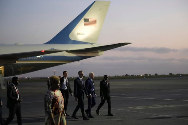 President Joe Biden walks with Angolan Foreign Minister Tete Antonio, right, after arriving at Quatro de Fevereiro international airport in the capital Luanda, Angola on Monday, Dec. 2, 2024, on his long-promised visit to Africa. (AP Photo/Ben Curtis)