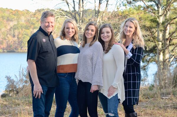 The Evans family — Bryan, Mackenzie, Lexi, Chandley and Shanon — stand on the lot where they are building a house on Lake Arrowhead. The home should be completed by next May.