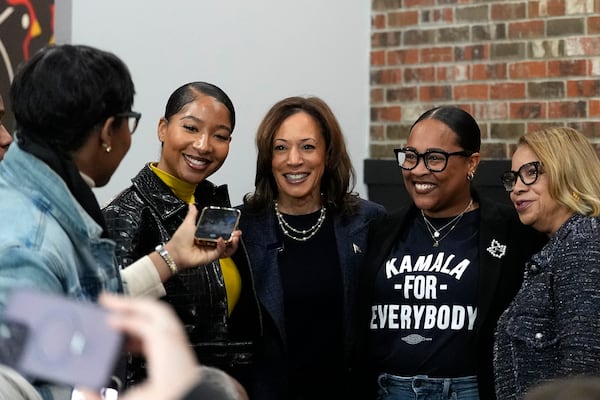 Democratic presidential nominee Vice President Kamala Harris, center, takes a photo with patrons during a campaign stop at Kuzzo's Chicken and Waffles in Detroit, Sunday, Nov. 3, 2024. (AP Photo/Jacquelyn Martin)