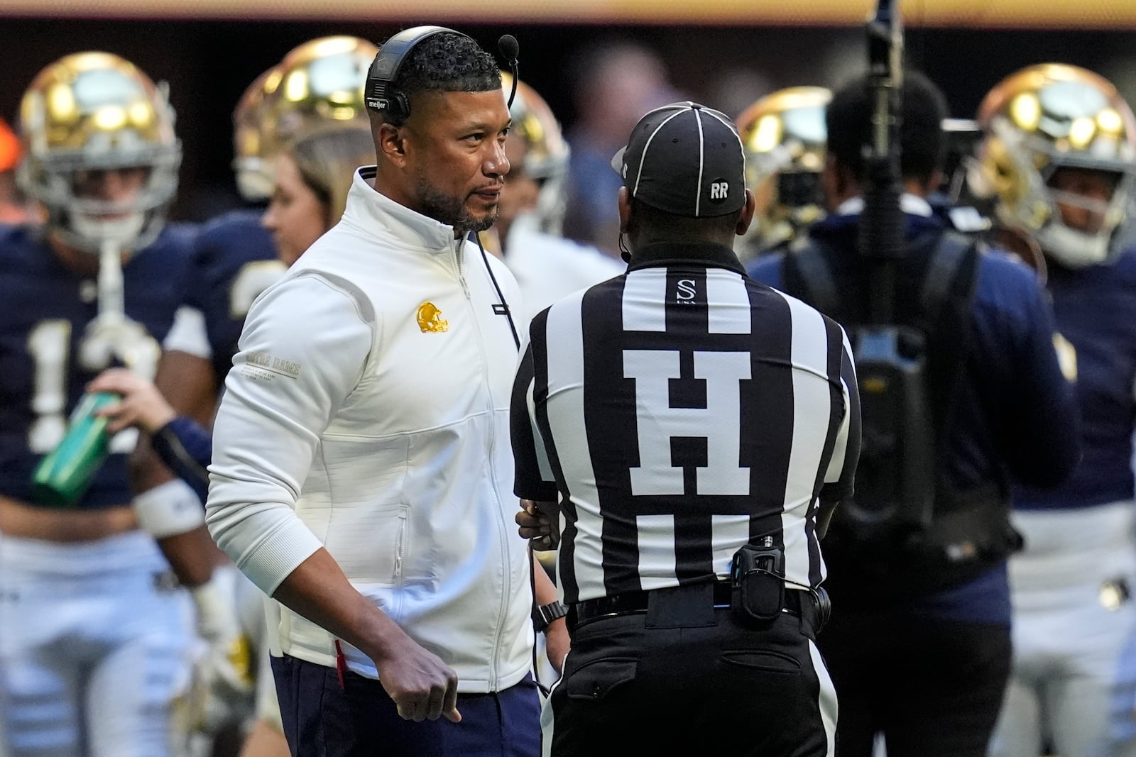 Georgia Tech head coach Brent Key speaks with an official during the first half of an NCAA college football game against Notre Dame, Saturday, Oct. 19, 2024, in Atlanta. (AP Photo/Mike Stewart)