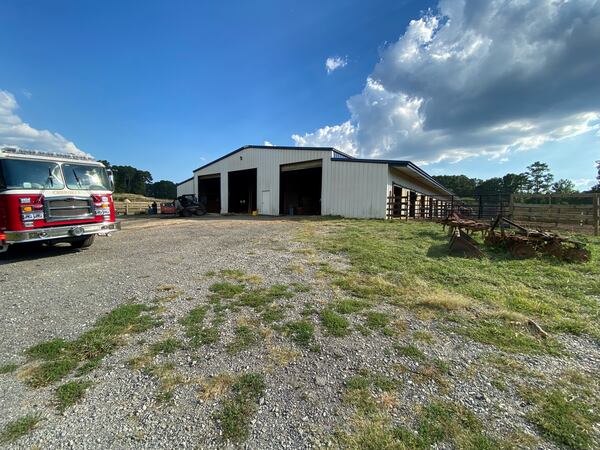 Cherokee County firefighters put out an equipment fire at a horse barn, resulting in no injuries to the 28 horses housed there.