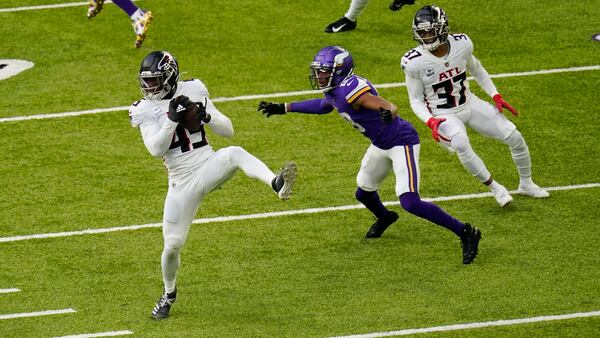 Atlanta Falcons linebacker Deion Jones (45) intercepts a pass intended for Minnesota Vikings wide receiver Justin Jefferson (18) during Minnesota's first offensive play  Sunday, Oct. 18, 2020, in Minneapolis. (Charlie Neibergall/AP)