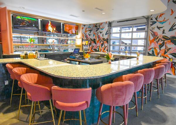 The flamboyant interior of Birdcage features a terrazzo bar with mauve barstools. Courtesy of Liz Attaway/@adventuresinatlanta