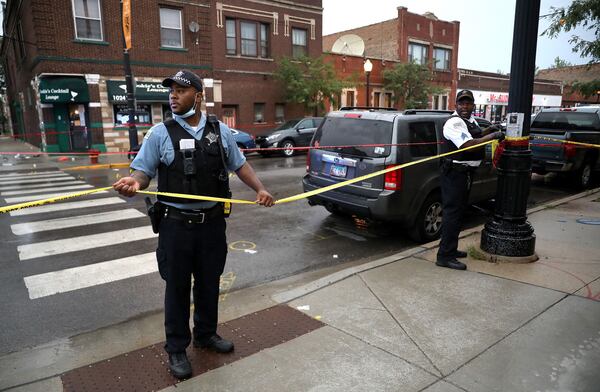 Chicago police investigate the scene of a mass shooting near 79th Street and Morgan Street in Chicago. (Chris Sweda/Chicago Tribune/TNS)