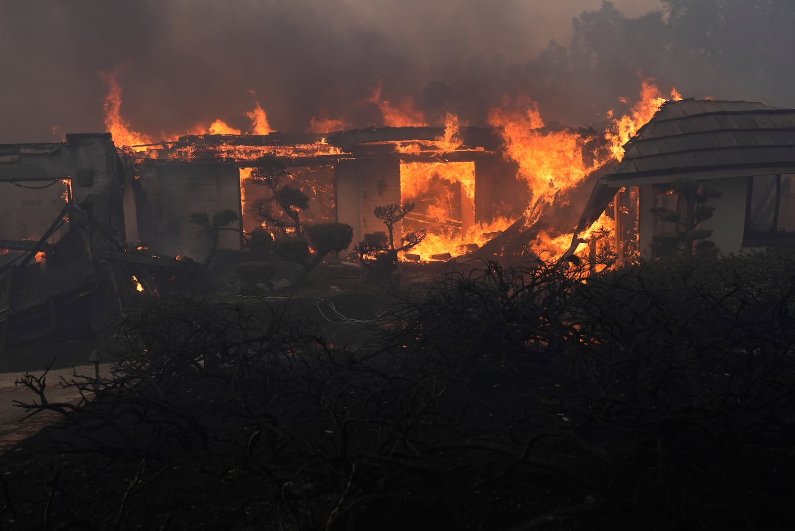 A home burns in the Mountain fire, Wednesday, Nov. 6, 2024, near Camarillo, Calif. (AP Photo/Marcio Jose Sanchez)