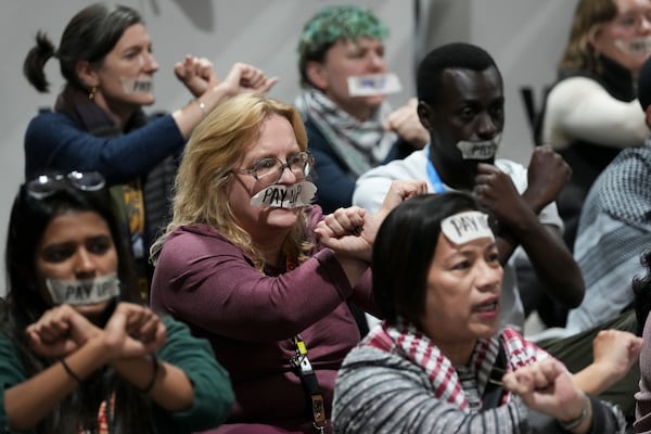 Activists participate in a demonstration for climate finance at the COP29 U.N. Climate Summit, Saturday, Nov. 23, 2024, in Baku, Azerbaijan. (AP Photo/Sergei Grits)