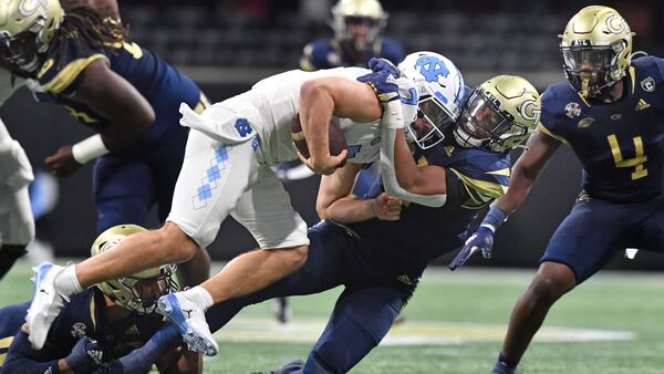 North Carolina's quarterback Sam Howell (7) is sacked by Georgia Tech's defensive lineman Kyle Kennard (31). (Hyosub Shin / Hyosub.Shin@ajc.com)