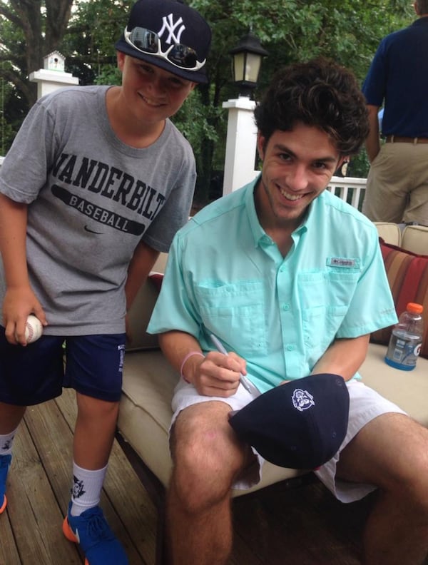 Dansby Swanson signs a cap for Bowen Mayfield.