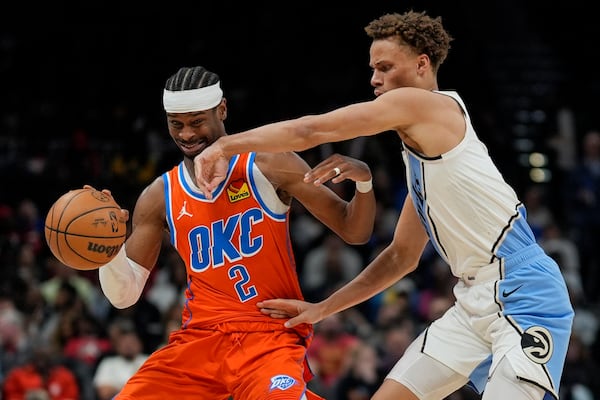 Hawks guard Dyson Daniels (right) giving Thunder star Shai Gilgeous-Alexander the business during Atlanta's loss on Friday.