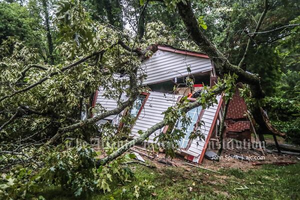 A tree fell along Peyton Avenue off Donald Lee Hollowell Parkway on Tuesday morning, crushing a home.