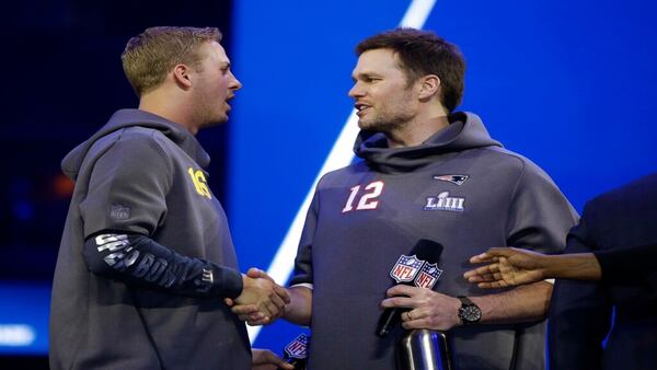 Los Angeles Rams' Jared Goff talks to New England Patriots' Tom Brady during Opening Night for the NFL Super Bowl 53 football game Monday, Jan. 28, 2019, in Atlanta. (AP Photo/Matt Rourke)