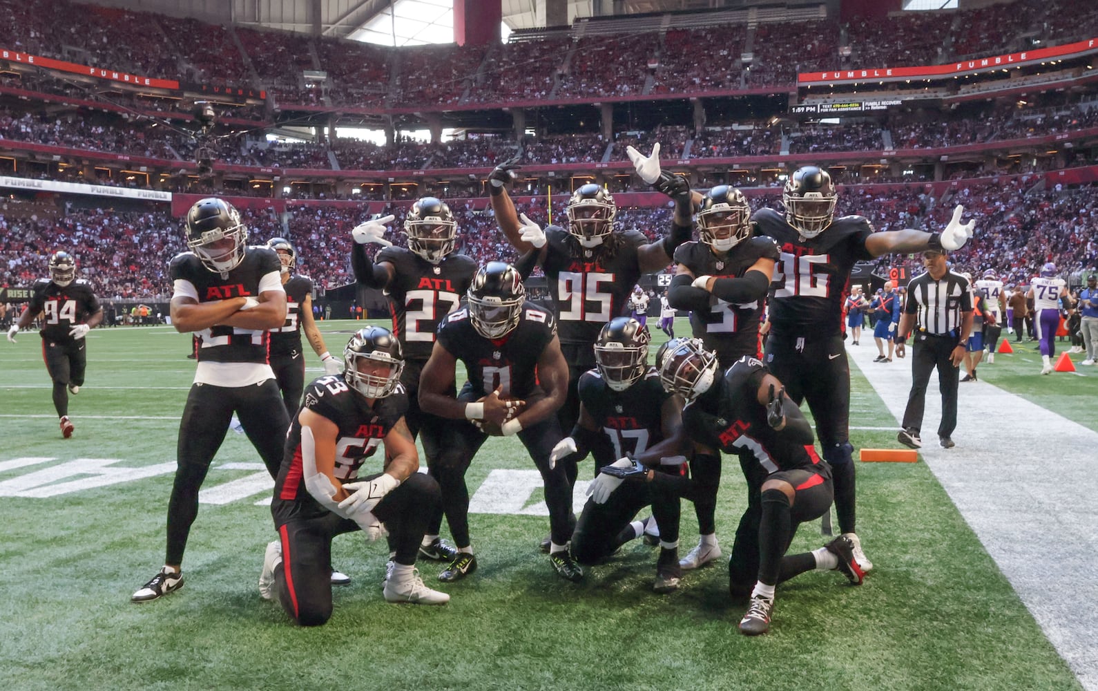 Atlanta Falcons celebrate after linebacker Lorenzo Carter (0) recovered a forced fumble by Minnesota Vikings quarterback Joshua Dobbs and returned it close the the goal line during the first half of an NFL football game in Atlanta on Sunday, Nov. 5, 2023. (Bob Andres for the Atlanta Journal Constitution)