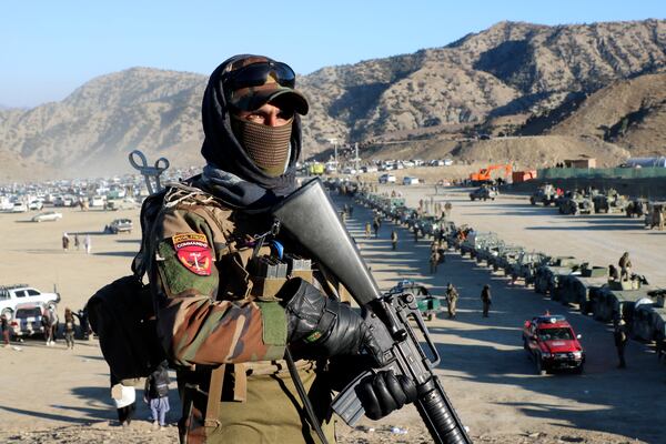 Taliban fighters stand guard during the funeral prayers of Khalil Haqqani, the minister for refugees and repatriation, during his funeral procession in eastern Paktia province, Afghanistan, Thursday, Dec. 12, 2024. (AP Photo/Saifullah Zahir)