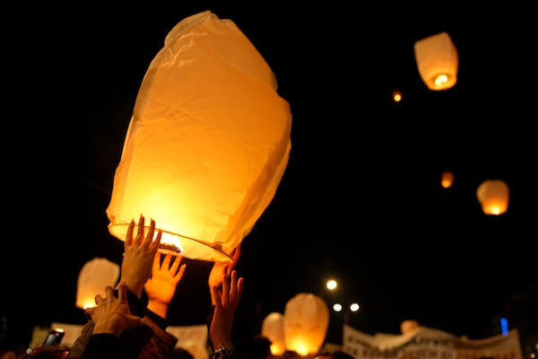 Protesters release lanterns during a rally, after the Greek opposition parties have challenged the country's center-right government with a censure motion in parliament over a devastating rail disaster nearly two years ago, in Athens, Wednesday, March 5, 2025. (AP Photo/Petros Giannakouris)