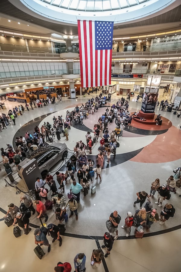 Lines for the main security checkpoint at Hartsfield-Jackson International Airport stretched through the domestic terminal atrium on Friday, June 28, 2024. Credit: John Spink / jspink@ajc.com