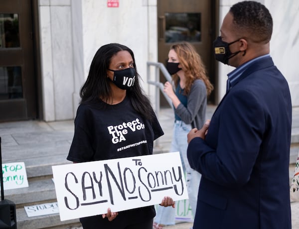 210427-Atlanta- Hannah Gebresilassie with Protect the Vote GA talks with State Rep. Derrick Jackson (D-Tyrone) in front of the University System of Georgia offices in Downtown Atlanta on Tuesday afternoon, April 27, 2021, before a protest against former Gov. Sonny Perdue becoming the new chancellor. Ben Gray for the Atlanta Journal-Constitution