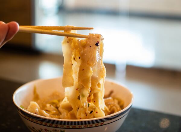 Rustic, hand-torn noodles from Xi’an Gourmet House are topped with shredded pork and Sichuan pickled cabbage. CONTRIBUTED BY HENRI HOLLIS