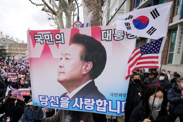 Supporters of impeached South Korean President Yoon Suk Yeol attend a rally to oppose his impeachment near the Constitutional Court in Seoul, South Korea, Tuesday, Feb. 25, 2025. The letters read "The people's president." (AP Photo/Ahn Young-joon)