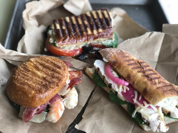 Some panini options (from left): baked shrimp, shaved Parmesan, fresh basil and a bacon slice on a sourdough roll; white bean hummus, with mixed lettuce greens and fresh tomato slices on pretzel bread; grilled chicken breast, spinach, shredded Gruyere, and pickled red onions on a French baguette. CONTRIBUTED BY KELLIE HYNES