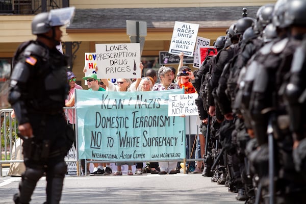 Police march into the square before the start of a pro-Trump rally in Dahlonega on Saturday, September 14, 2019. STEVE SCHAEFER / SPECIAL TO THE AJC