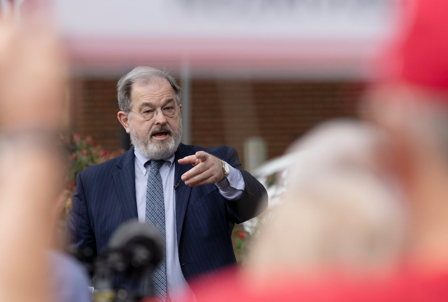 John Christy, attorney for the group opposing the measure, speaks with them after the Morgan County board of assessors voted to approve the Rivian tax exemption proposal in Madison on Wednesday, May 25, 2022.   (Bob Andres / robert.andres@ajc.com)