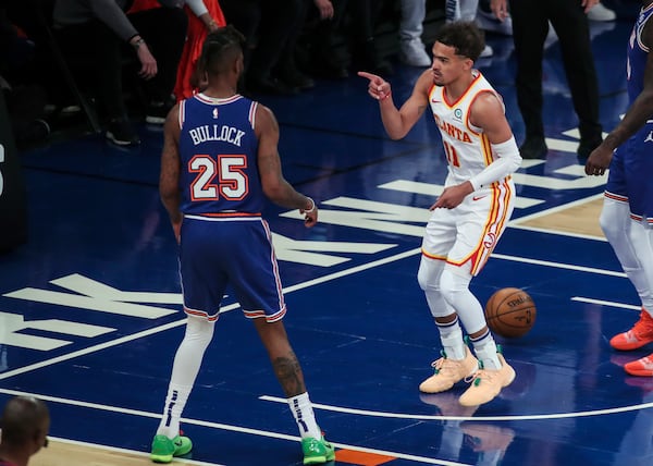 Atlanta Hawks guard Trae Young (11) points to New York Knicks forward Reggie Bullock (25) after scoring in the first quarter of Game 5 of an NBA basketball first-round playoff series Wednesday, June 2, 2021, in New York. (Wendell Cruz/Pool Photo via AP)