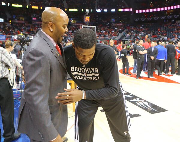 041915 ATLANTA: Hawks public announcer Ryan Cameron gets a hug from former Hawks player Joe Johnson during pregame warmups for the first round home playoff game against the Nets on Sunday, April 19, 2015, in Atlanta. Curtis Compton / ccompton@ajc.com 041915 ATLANTA: Hawks public announcer Ryan Cameron gets a hug from former Hawks player Joe Johnson during pregame warmups for the first round home playoff game against the Nets on Sunday, April 19, 2015, in Atlanta. He was booed lustily throughout Sunday's game whenever he touched the ball but Ryan keeps good relations with ex-Hawks, regardless of what the fans think. Curtis Compton / ccompton@ajc.com