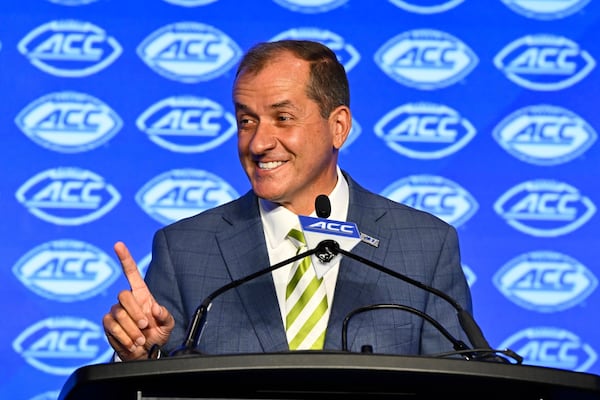 FILE - Atlantic Coast Conference commissioner Jim Phillips smiles during an NCAA college football news conference at the ACC media days, July 22, 2024, in Charlotte, N.C. (AP Photo/Matt Kelley, File)