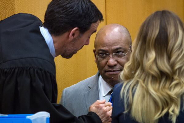 Fulton County Chief Assistant District Attorney Clint Rucker, center, talks with Judge Robert McBurney during day 12 of the Tex McIver murder trial last week. Steve Schaefer / For the AJC