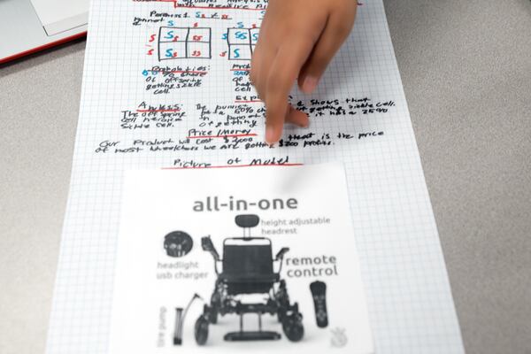 Seventh grader Dylan Burns points to his group’s Sickle Cell project created for the STEM Medical PBL showcase at Hull Middle School in Duluth on Friday, Jan. 13, 2023.  (Natrice Miller/natrice.miller@ajc.com) 