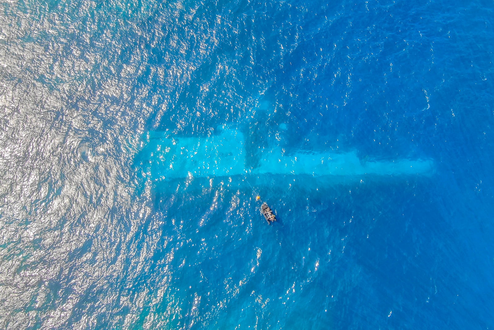 In this photo provided by the New Zealand Defence Force, divers survey the area around HMNZS Manawanui on the southern coast of Upulo, Samoa, after the Manawanui ran aground and sank on Oct. 6. (AC Jese Somerville/New Zealand Defence Force via AP)