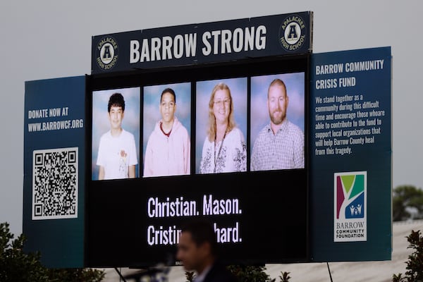 A electronic billboard showing 14-year-old Apalachee High School students Christian Angulo and Mason Schermerhorn and teachers Cristina Irimie and Richard Aspinwall is seen at a vigil at Jug Tavern Park in Winder on Friday, Sept. 6, 2024. A 14-year-old Apalachee High School student is accused of shooting and killing the four and injuring nine others at the Barrow County high school on Wednesday. (Arvin Temkar / AJC)