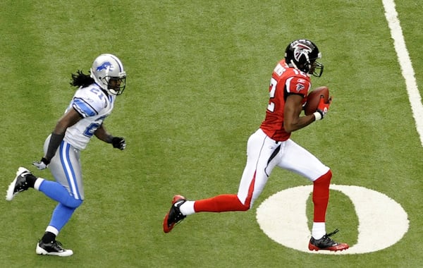 Wide receiver Michael Jenkins dashes to the end zone for a 62-yard touchdown reception - Matt Ryan's first career pass attempt. (Al Messerschmidt/Getty Images)