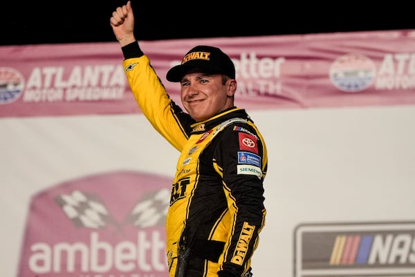 Christopher Bell celebrates victory after a NASCAR Cup Series auto race, Sunday, Feb. 23, 2025, in Hampton, Ga. (AP Photo/Mike Stewart)