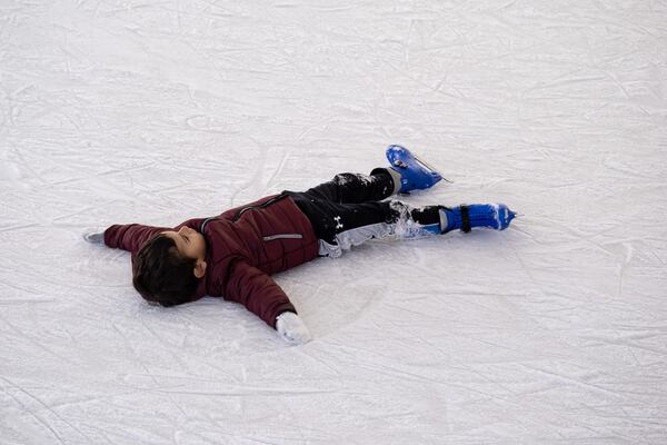 Nicolas Macedo, 3, was more interested in making snow angels than in skating at the Have an Ice Day rink in downtown Sugar Hill on Saturday afternoon, December 26, 2020. (Photo: Ben Gray for The Atlanta Journal-Constitution)