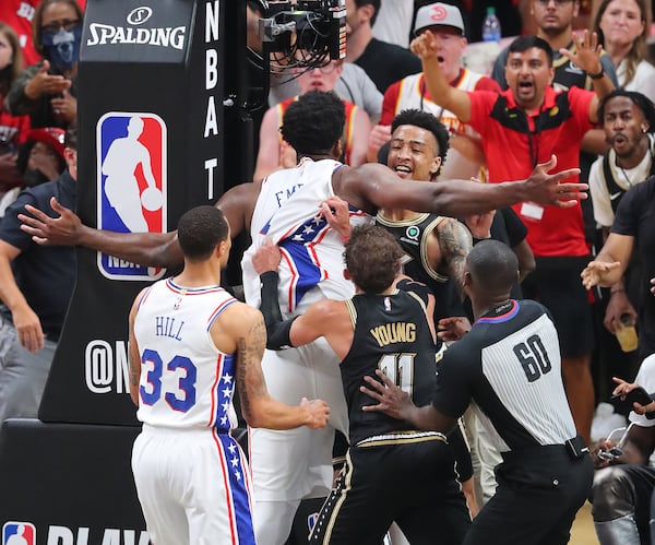 Philadelphia 76ers' Joel Embiid and Hawks forward John Collins scuffle in the fourth quarter.   “Curtis Compton / Curtis.Compton@ajc.com”