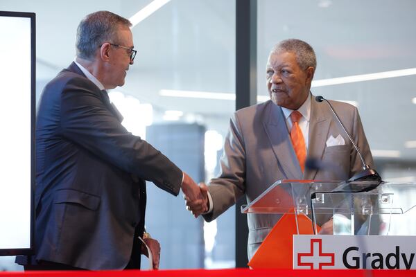 (Left to right) Grady Memorial Hospital CEO John Haupert shakes hands with Fulton County Board of Commissioners Chair Rob Pitts during the ribbon cutting ceremony for Correll Pavilion on Monday March 13, 2023. The 10-story wing will house outpatient surgeries and other non-emergency services at Grady. (Natrice Miller/The Atlanta Journal-Constitution)