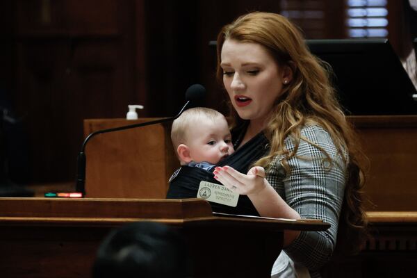 State Rep. Lauren Daniel, R-Locust Grove holds her five-month-old son Zane. She introduced a bill to quadruple fines for motorists passing a school bus. (Miguel Martinez / miguel.martinezjimenez@ajc.com)