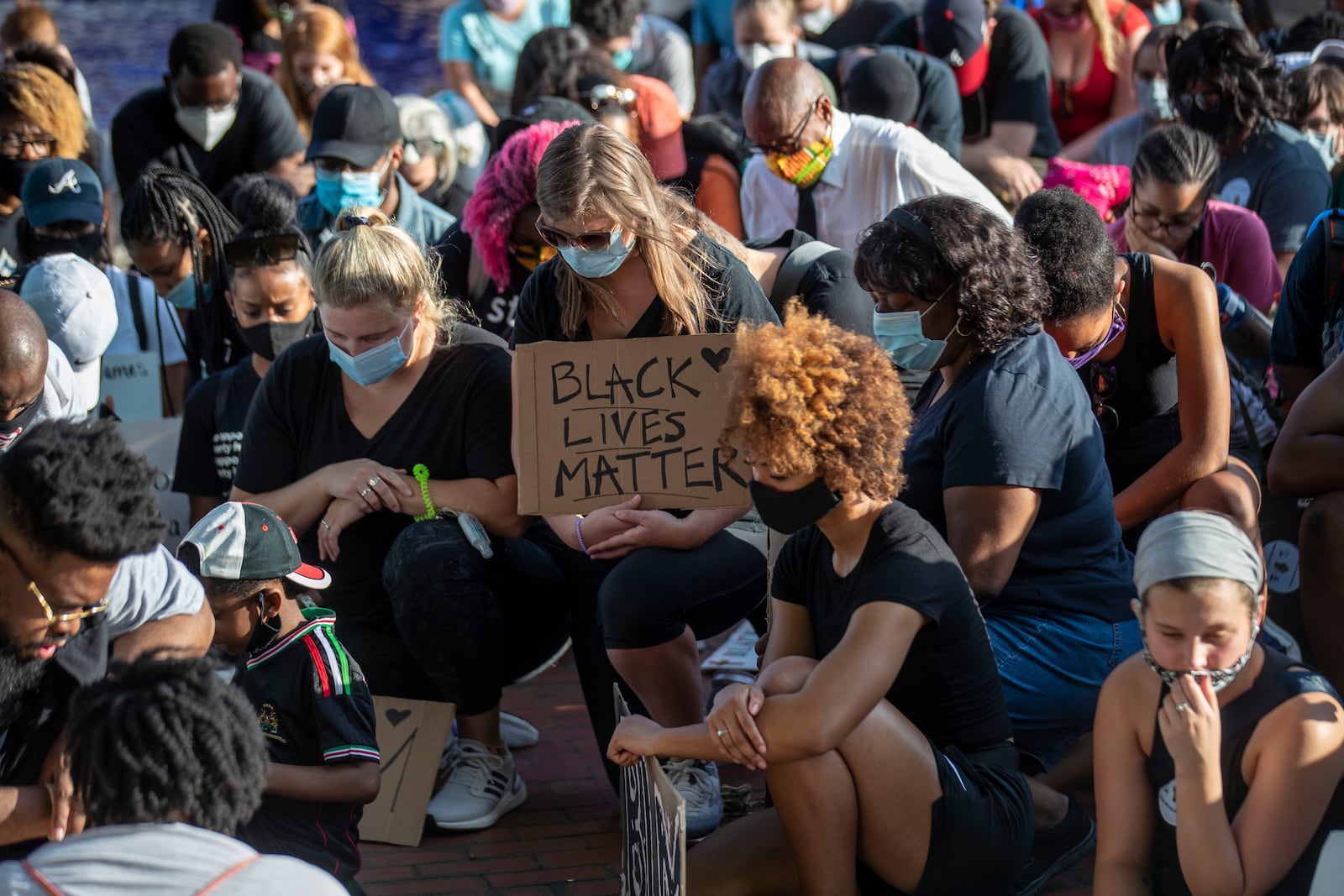 Demonstrators with the Public Defenders for Black Lives rally kneel as they take a moment of silence near the crypt of Martin Luther King Jr. and Coretta Scott King following their rally at Ebenezer Baptist Church during the 11th day of protests in Atlanta. The demonstrators were silent for 8 minutes, to honor the life of George Floyd. (Photo: Alyssa Pointer/AJC)