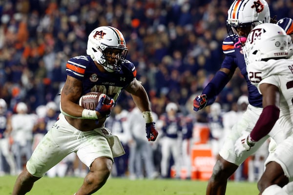 Auburn running back Jarquez Hunter (27) carries the ball in for a touchdown against Texas A&M during the first overtime of an NCAA college football game, Saturday, Nov. 23, 2024, in Auburn, Ala. (AP Photo/Butch Dill)