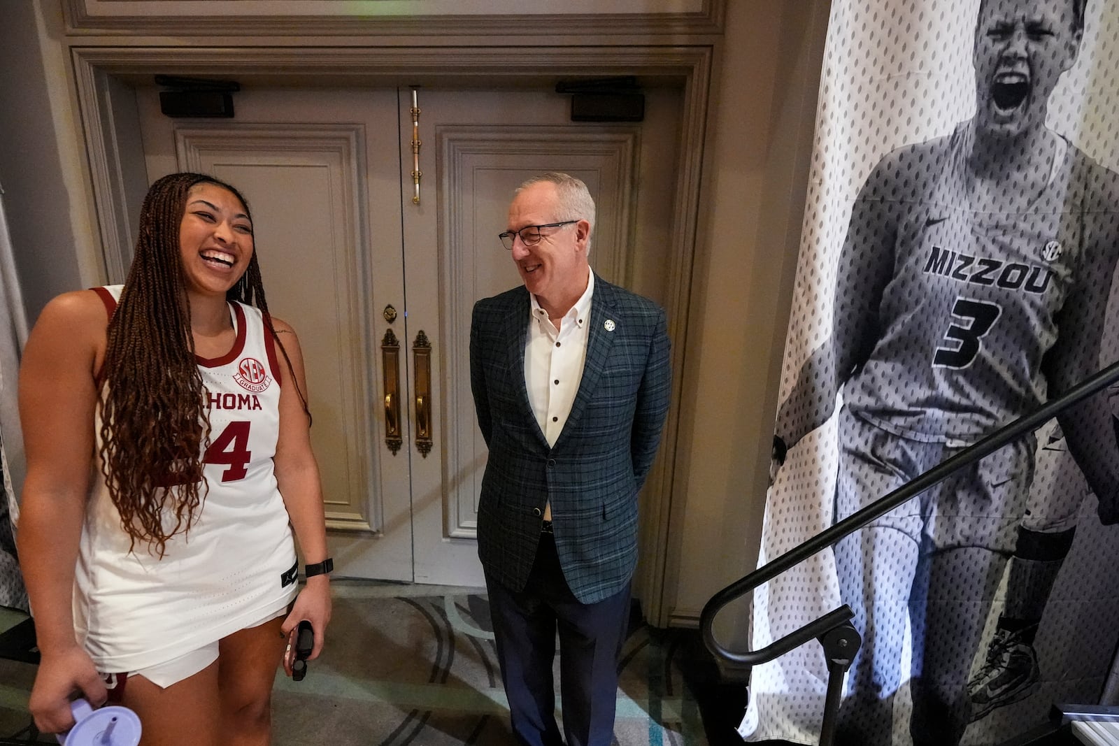 Oklahoma player Skylar Vann, speaks with SEC Comissionoer Greg Sankey, at the Southeastern Conference NCAA women's college basketball media day, Wednesday, Oct. 16, 2024, in Birmingham, Ala. (AP Photo/Mike Stewart)