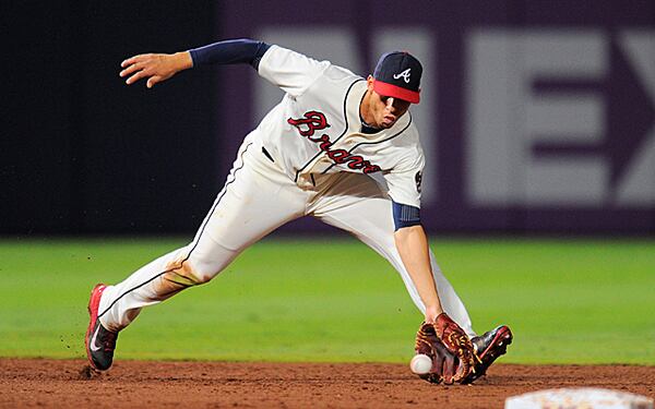 Jul 28, 2013; Atlanta, GA, USA; Atlanta Braves shortstop Andrelton Simmons (19) fields a ground ball to begin a double play against the St. Louis Cardinals during the sixth inning at Turner Field. The Braves defeated the Cardinals 5-2. Mandatory Credit: Dale Zanine-USA TODAY Sports Andrelton Simmons was still at least one year away from arbitration eligibility when the Braves signed him last week to a seven-year, $58 million contract.