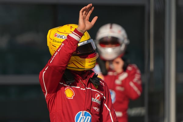 Ferrari driver Lewis Hamilton of Britain waves to his supporters after qualifying session for the Chinese Formula One Grand Prix at the Shanghai International Circuit, Shanghai, Saturday, March 22, 2025. (AP Photo/Andy Wong)