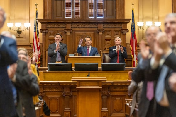 Gov. Brian Kemp salutes legislators during the State of the State speech he gave Wednesday at the Capitol in Atlanta. (Arvin Temkar / arvin.temkar@ajc.com)