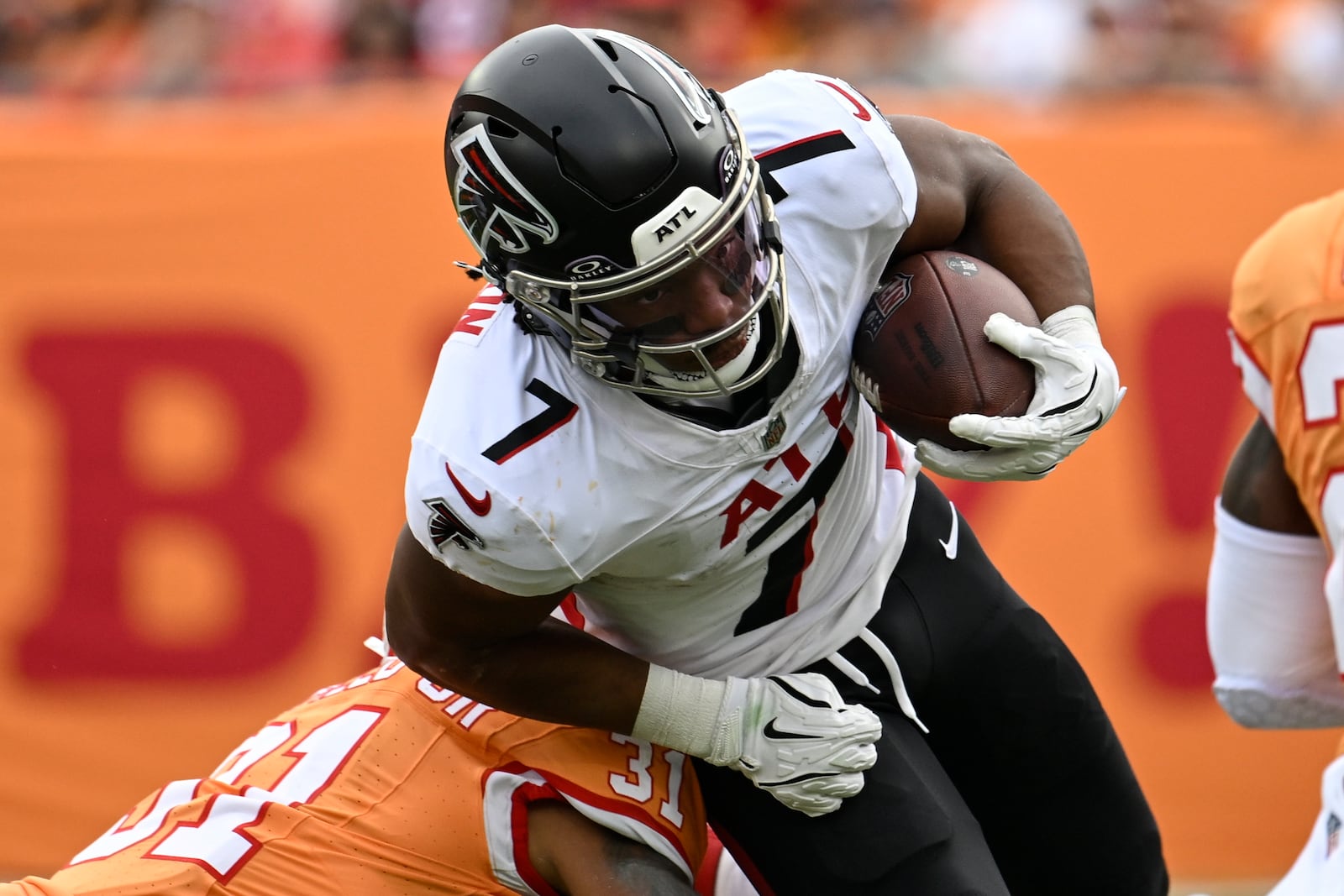 Atlanta Falcons running back Bijan Robinson (7) runs against Tampa Bay Buccaneers safety Antoine Winfield Jr. (31) during the first half of an NFL football game, Sunday, Oct. 27, 2024, in Tampa. (AP Photo/Jason Behnken)