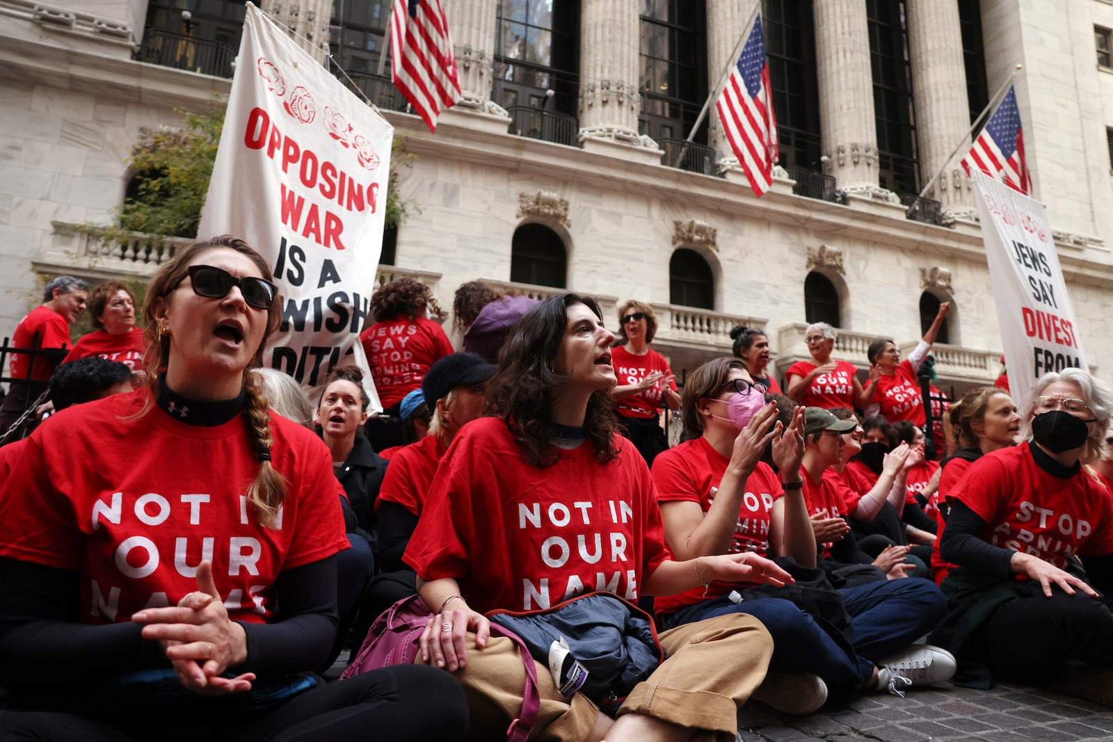 Anti-Israel protesters occupy an area in front of the New York Stock Exchange, Monday, Oct. 14, 2024. (AP Photo/Yuki Iwamura)