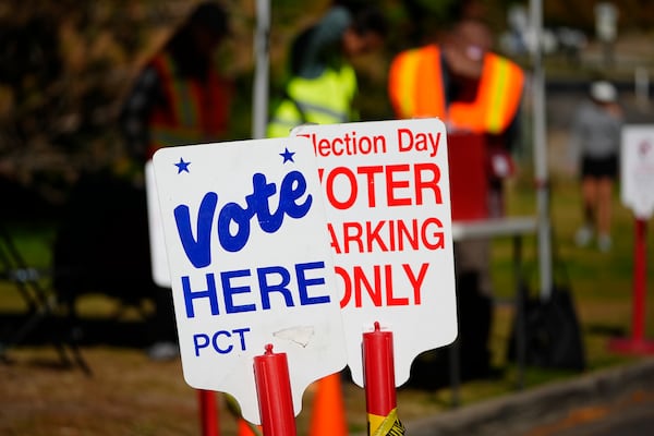 Signs direct voters to a ballot drop-off location Oct. 25, 2024, in Washington Park in Denver. (AP Photo/David Zalubowski)