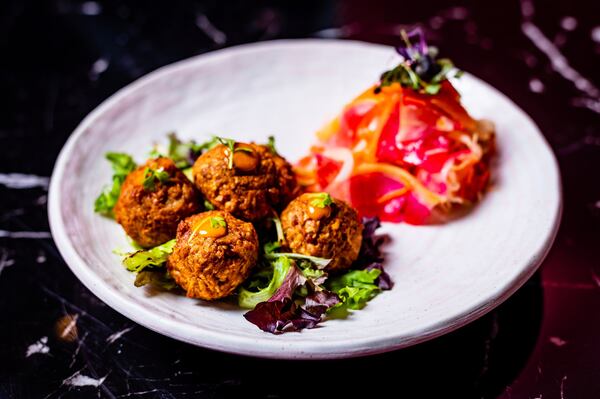 Akra (left) are hush puppies made from taro root. Here they’re served with a side of pikliz (Haitian relish) at Rock Steady. CONTRIBUTED BY HENRI HOLLIS