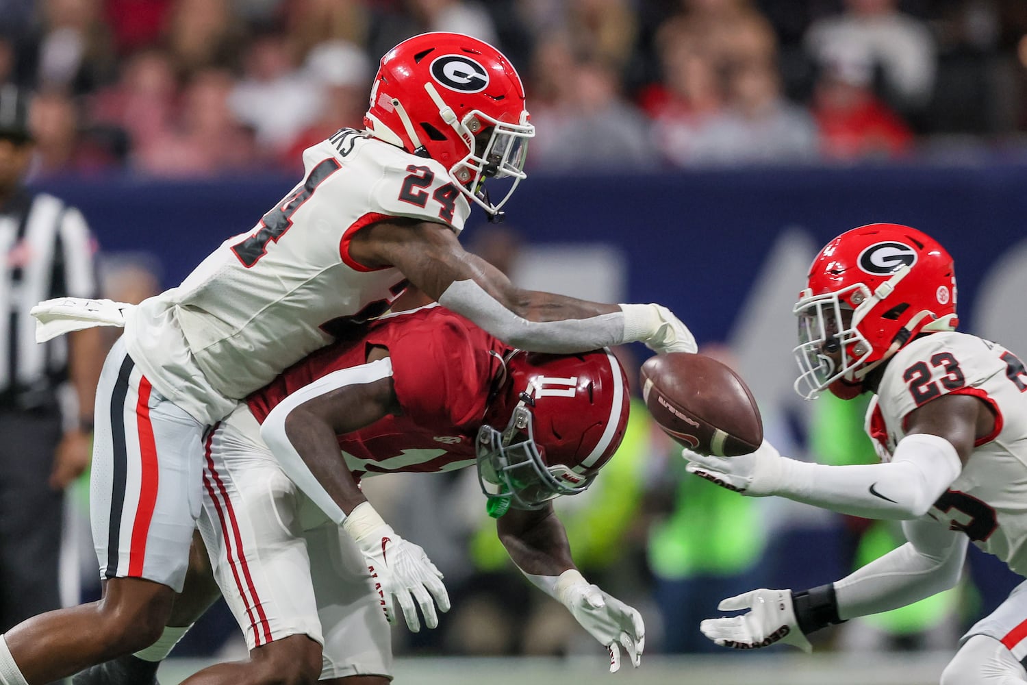 Georgia Bulldogs defensive back Malaki Starks (24) blocks Alabama Crimson Tide wide receiver Malik Benson (11) as  defensive back Tykee Smith (23) backs him up during the first half of the SEC Championship football game at the Mercedes-Benz Stadium in Atlanta, on Saturday, December 2, 2023. (Jason Getz / Jason.Getz@ajc.com)